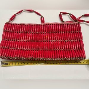 Vintage red paper bead purse. Pink lined fabric and very cute!